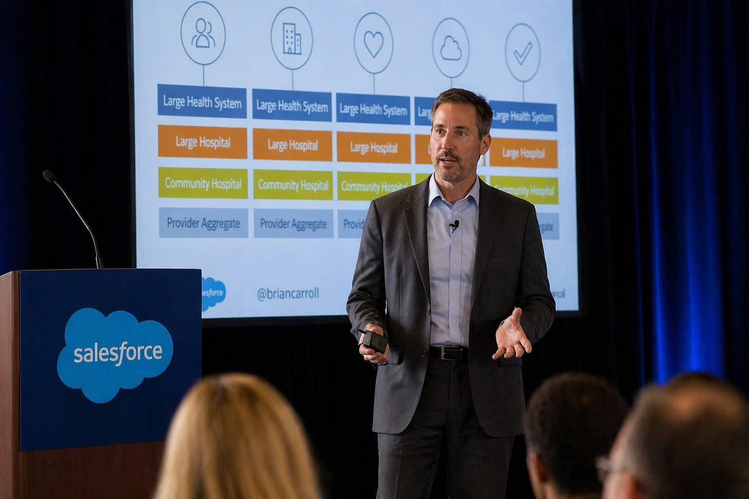 Man presenting healthcare system chart at Salesforce conference
